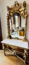 A George III revival mirrored back giltwood and marble top console table, in a John Linnell “The