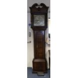 An 18th century oak longcase clock, the hood with swan neck pediments and carved wooden paterae,