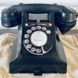 A Bakelite ebonised telephone with a pullout tray.  ***Offsite location***