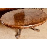 An early Victorian burr walnut and satinwood strung oval loo table, raised on later oak carved saber