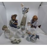 A collection of Lladro figures 2 of which are seated boy and girl  tallest figure stands 33cm