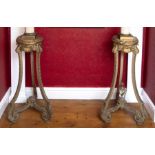 A pair of, 19th Century, painted wood carved and gilded tripod torcheres, each with composite marble