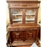 A 20th century oak dresser, moulded cornice, over twin panel doors, foliage carving throughout,