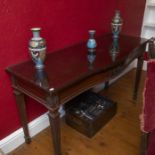 A mahogany serpentine fronted serving table in the manor or Robert Adam, circa 1910, with central