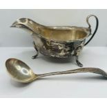 A silver sauce pot and ladle along with a silver christening set:  The sauce pot with a scalloped