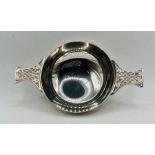 Norse style footed quaich, with intertwined serpent decoration to the handles. Hallmarked for