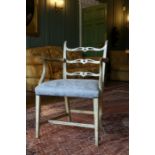 A George III cream painted fruitwood open armchair with triple cupids bow back, stuffed seat, on