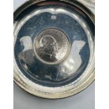 A sterling silver candle holder, formed as a heat shaped dish, plus a Churchill commemorative silver
