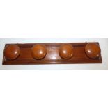 A Large pine wall hanging coat hook rack, with hooks attached. With 4 large, knobbed handles. 77
