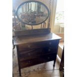 An Edwardian mahogany dressing table, circa 1910, oval mirror held by obelisk shaped supports