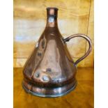 A Victorian conical copper 2 gallon measure with loop handle, 40cm high condition: some denting to