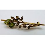 A yellow metal unmarked late 19th century seed pearl and peridot foliate bar brooch. Gross weight