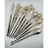 A selection of 11 attractive silver button hooks. (11)
