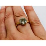 A 3ct plus round brilliant cut solitaire diamond ring in a yellow metal setting , stamped 18k.