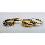 Four gold rings: Two 1920s to 1930s three stone diamond rings in 18ct gold and platinum, both size