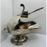 A Sterling silver sugar bowl in the form of a coal scuttle and shovel, with decorative  pattern, and