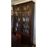 A Continental mahogany veneered bookcase cabinet, early 19th Century, with quarter moulded