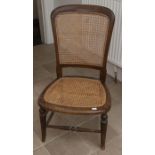 A late Victorian caned panelled back nursing chair. Condition: Good, slight water damage