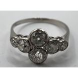 An Edwardian white-grey metal dress ring, with millegrain set old European Cut diamonds. Approximate