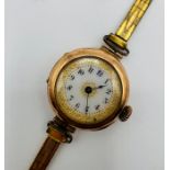 An early 20th century 9ct gold ladies wristwatch with an attractive decoratively gilded white