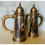A pair of 1920s silver coffee pots with side handles in early plastic, gross weight 421 grams and