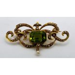 A 15ct stamped yellow metal Art Nouveau style peridot and seed pearl brooch. Gross weight approx 4.8