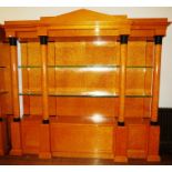 A pair of large Biedermeier style satin birch open bookcase cabinets each with pedimented frieze