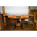A Biedermeier style satin birch and ebonized sofa table with drop flaps short frieze drawer. on