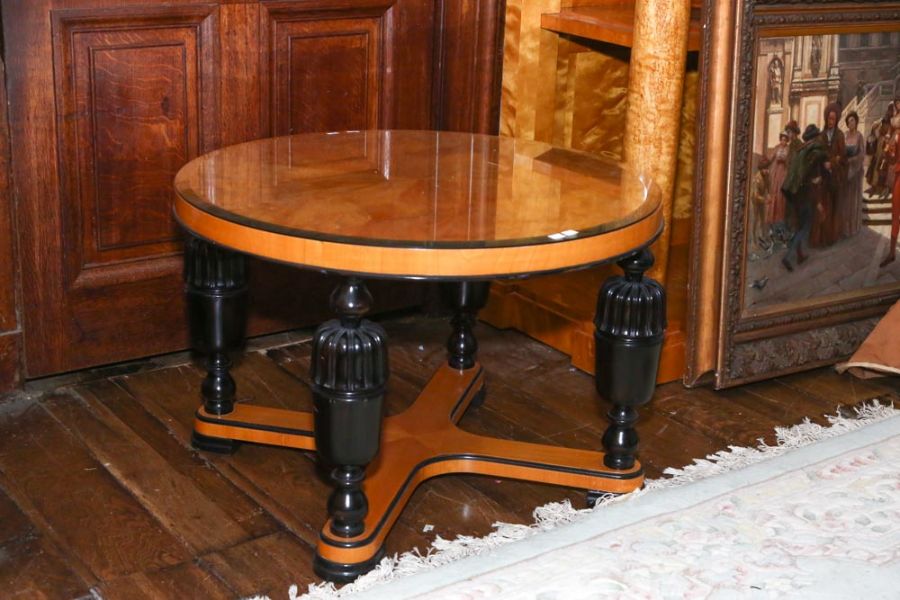 A Biedermeier style satin birch and ebonized occasional table with circular top on baluster turned