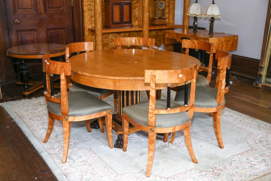 A Biedermeier style satin birch and ebonized extending dining table on fluted column, concave