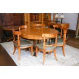 A Biedermeier style satin birch and ebonized extending dining table on fluted column, concave