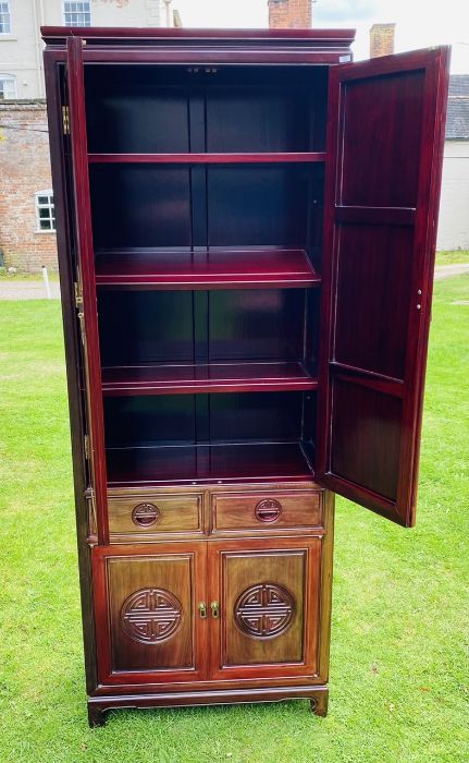 A Chinese hardwood cabinet, the upper section with moulded cornice above a pair of doors with carved - Bild 3 aus 4