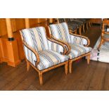 A pair of satin birch Biedermeier style armchairs upholstered in striped fabric with curved arms and