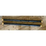 A pair of Regency style ebonized and gilt curtain poles inlaid with small stars and with reeded