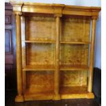 A large Biedermeier style satin birch breakfront etagere with moulded frieze above three open