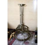 A brass Secessionist style chandelier with rods supporting pierced brass frame in low relief and