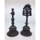 Two 20th century Indian bronze bells, the cast handles with deity finials, the tallest 31.5cm. (2)