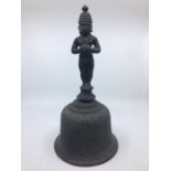 A large Indian bell, with associated cast bronze Hanuman finial, height 35cm