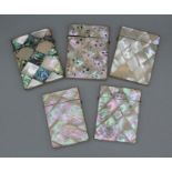 Five Victorian mother-of-pearl card cases, all with geometric pattern, one plain; one with