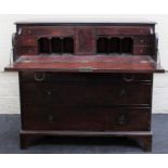 An early 19th century mahogany secretaire chest, the fitted fall over three graduated long drawers