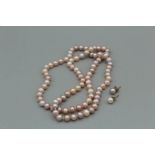 Strand of pinkish cultured pearls with two mismatched pearl studs, in case