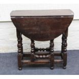 A small, part 18th century oak gateleg table, the later top with twin demi-lune drop leaves over end