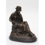 A hollow cast bronze, after the antique, of a classically attired young woman, seated cross