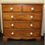 A 19th century mahogany chest of two short and three long drawers with white ceramic knop handles,