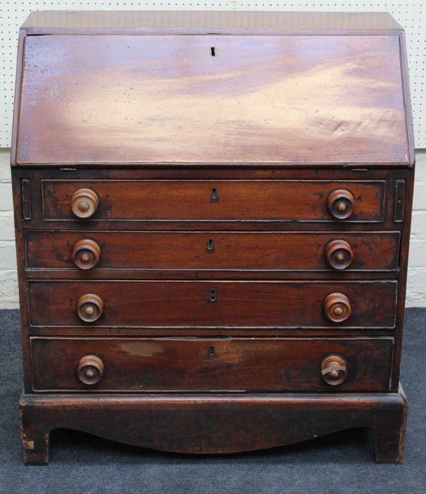 A 19th century mahogany bureau, the fall enclosing a simply fitted interior, over four graduated