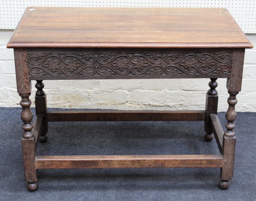 An 18trh century style oak side table, the rectangular planked top over blind fret carved frieze, on