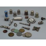 A collection of silver and white metal to include various charms (whistles, car, doll, bear); a