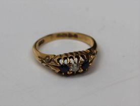 An 18ct gold three stone ring, two sapphires and an old mine cut diamond, gross weight approx 4.3gm,