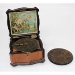 An Edwardian table top Polyphon, in a mahogany venner case, with ten eight inch discs. Retail