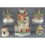 A group of nineteenth and twentieth century Staffordshire cottage money boxes and a pastille burner.